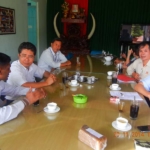 five mens discussing around the table while tasting a tea